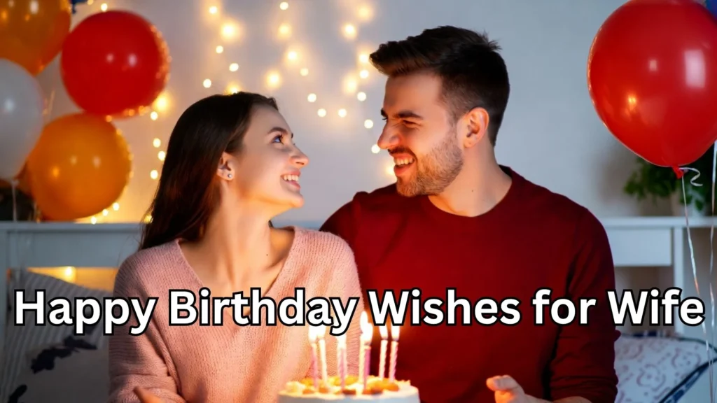 Husband and wife smiling at birthday cake with candles